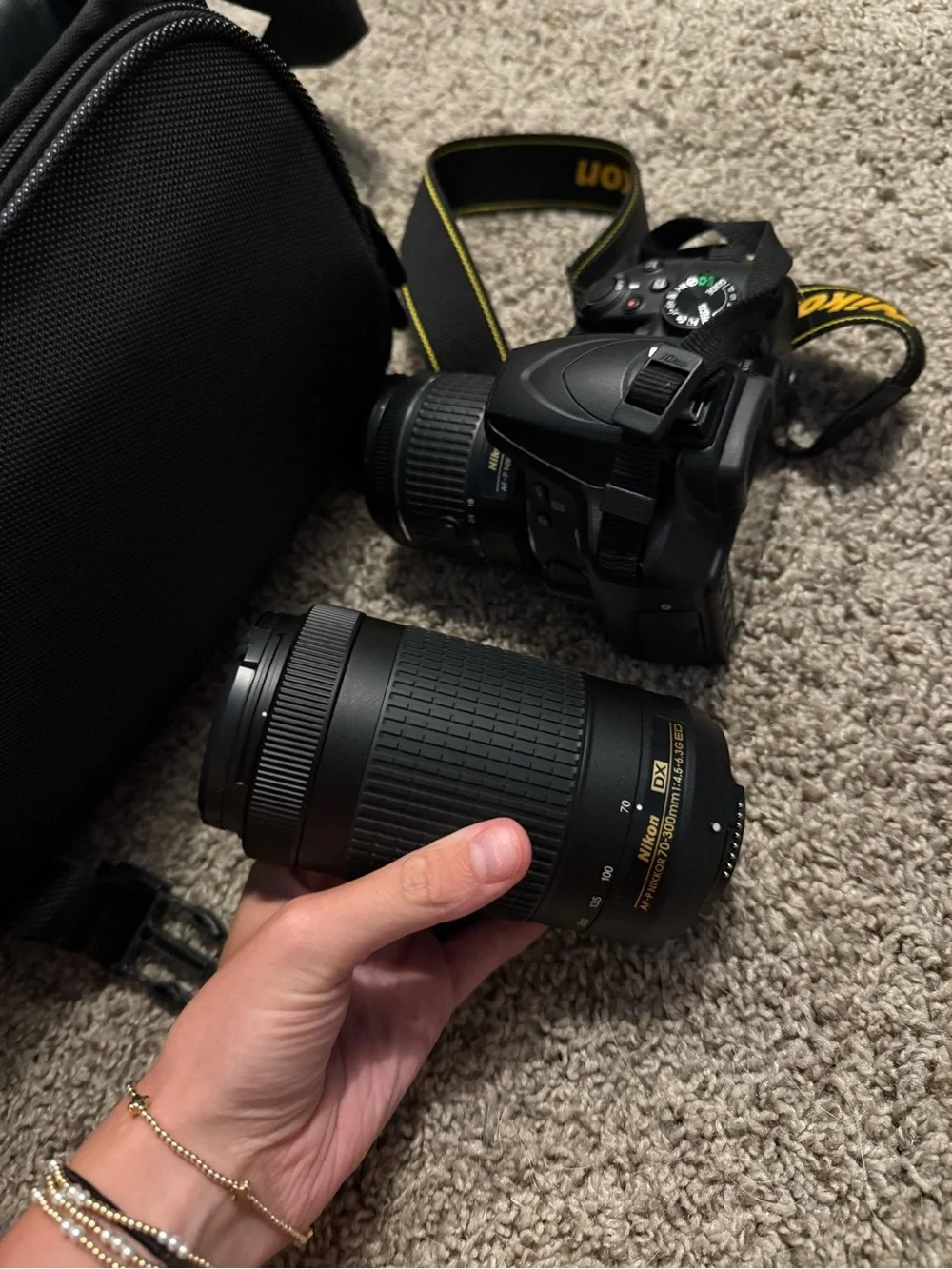 Nikon Black DSLR with Zoom Lens and Branded Neck Strap